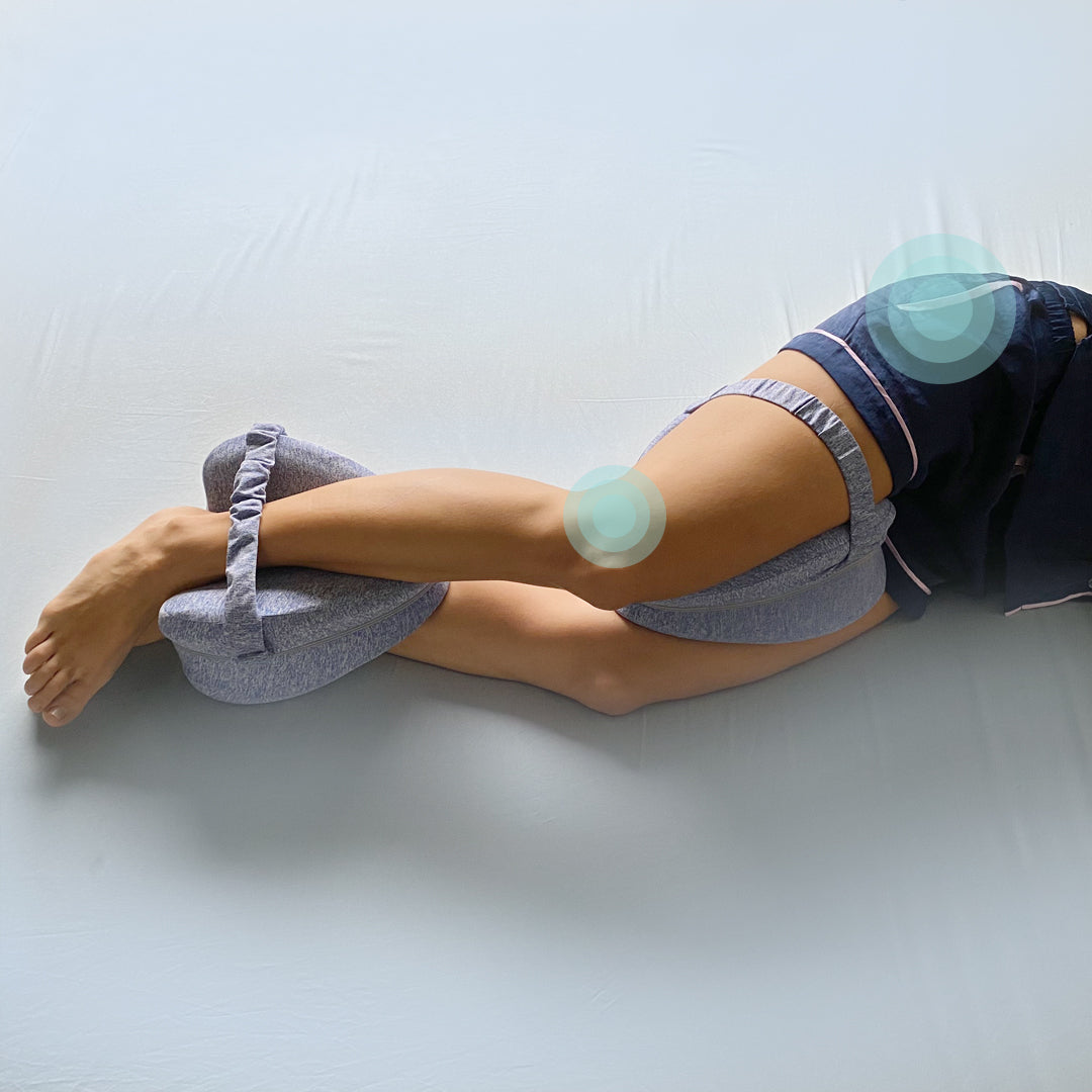 side sleeper woman using Zleep's leg and knee pillow to prevent hip, lower back, sciatica and knee pain